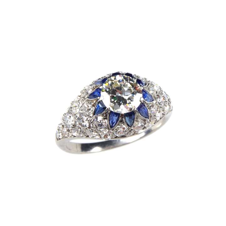 Round brilliant cut diamond bombe cluster ring, with sapphire accents